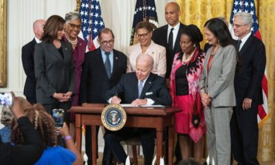 Karen Bass stands behind President Joe Biden as he signs an executive order on policing in the presence of Vice President Kamala Harris, far left, and other members of the House of Representatives and Senate. Facebook photo.