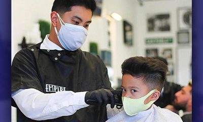 Drew DeGuzman cuts a child’s hair. Photo courtesy of Empire Barbershop.