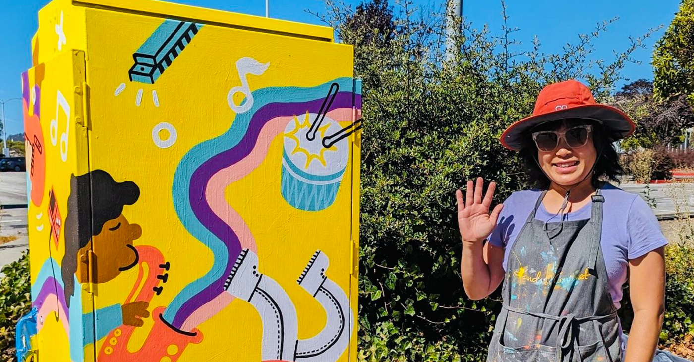 An artist stands by their work that transformed the utility box from drab to fab. Photo courtesy of the City of El Cerrito.