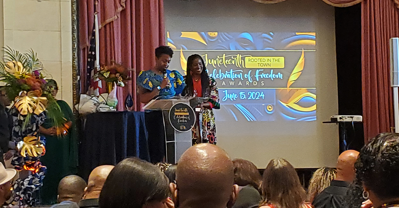 Councilmember Treva Reid presents honoree Children's Fairyland Executive Director Kymberly Miller with the Celebration of Freedom Award at the Juneteenth Rooted In the Town Celebration of Freedom Awards in downtown Oakland. Photo by Carla Thomas.