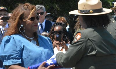 Carol Cherry, left, was presented with the Stars and Stripes flag by Kelli English, right, from the National Park Service to conclude the ceremony. Her father, Cyril Oscar Sheppard, Jr., was one of the 50 Black sailors convicted of mutiny after the explosions at Port Chicago killed 320 people in 1944. CBM photo by Antonio R. Harvey