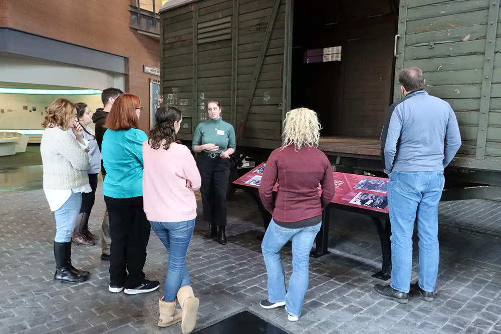 Participants in the Zekelman Holocaust Center's teacher education program view Holocaust artifacts up close during a museum tour. Photo courtesy the Nissan Foundation.