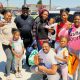 Rev. Andre Shumake, far right, and Antwon Cloird, far left, pose with recipients of the back-to-school supplies. Photo by Mike Kinney.