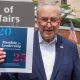 U. S. Senator Charles Schumer holds briefing in front of VA Hospital in New York on July 28, 2024 while holding photo illustrations on GOP 'Project 2025' plan as it will erode benefits for veterans. (Shutterstock)