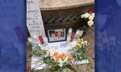 People place flowers and other items on the altar for Sonya Massey in front of the mural of police victim Breonna Taylor at 15thand Broadway at the Anti Police Terror Project’s response to a national call for action on July 28. Photo by Daisha Williams.