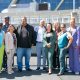 Mayor Sheng Thao, Councilmembers Nikki Bas and At-Large Councilmember Rebecca Kaplan celebrated the signing and the receipt of the first round of payments from some of the members of the African American Sports and Entertainment Group to purchase the Oakland/Alameda County Coliseum Complex. Left to right: Jonathan Jones, Alan Dones, C.J.Johnson, John Jones III, Nikki Bas, Ray Bobbitt, Ryan Richardson, Mayor Sheng Thao, Emily Weinreb, Rebecca Kaplan, Shonda Scott, Samantha Wise,Gay Plair Cobb and Paul Cobb. Photo by Kevin Hicks.