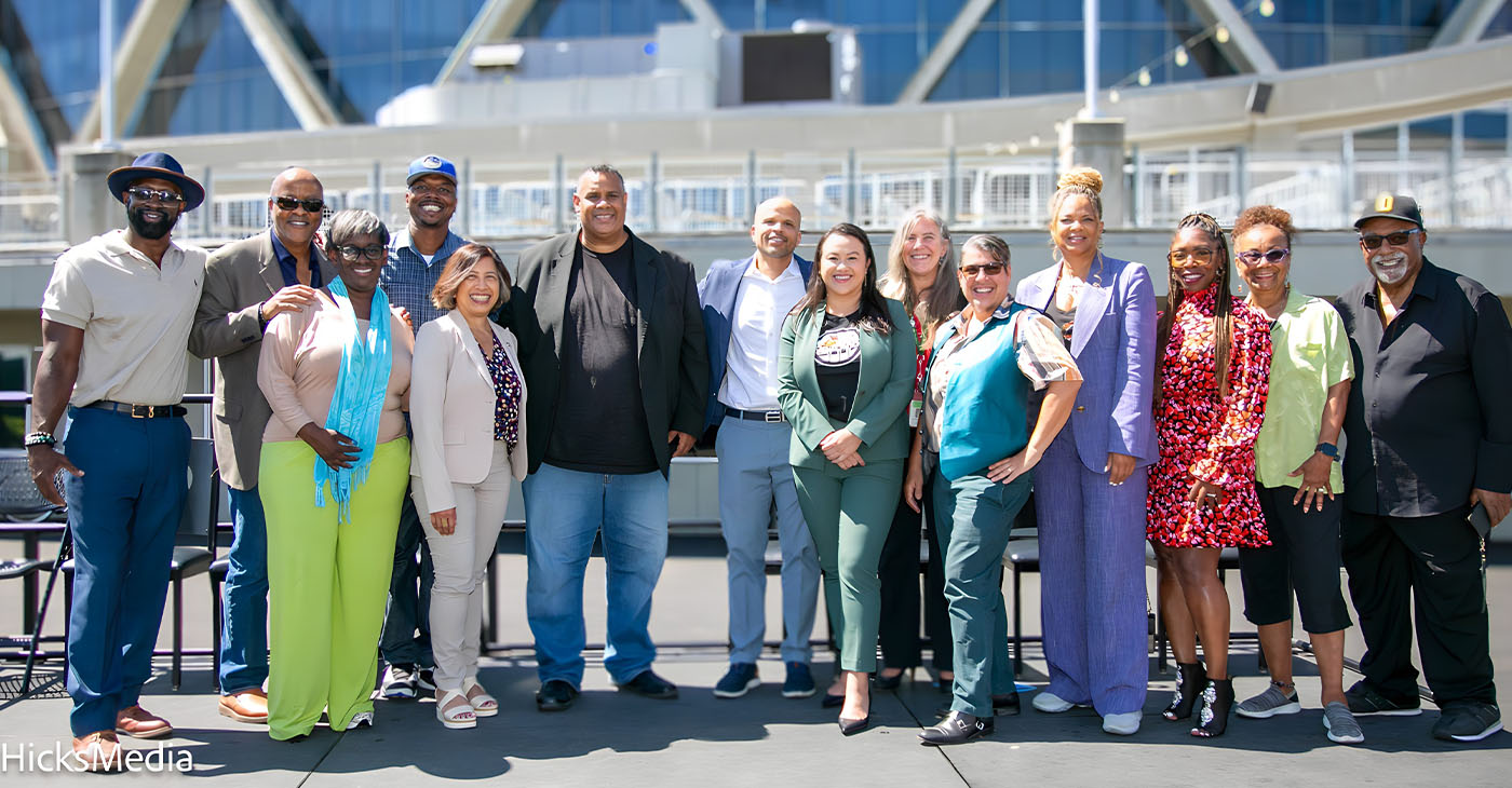 Mayor Sheng Thao, Councilmembers Nikki Bas and At-Large Councilmember Rebecca Kaplan celebrated the signing and the receipt of the first round of payments from some of the members of the African American Sports and Entertainment Group to purchase the Oakland/Alameda County Coliseum Complex. Left to right: Jonathan Jones, Alan Dones, C.J.Johnson, John Jones III, Nikki Bas, Ray Bobbitt, Ryan Richardson, Mayor Sheng Thao, Emily Weinreb, Rebecca Kaplan, Shonda Scott, Samantha Wise,Gay Plair Cobb and Paul Cobb. Photo by Kevin Hicks.