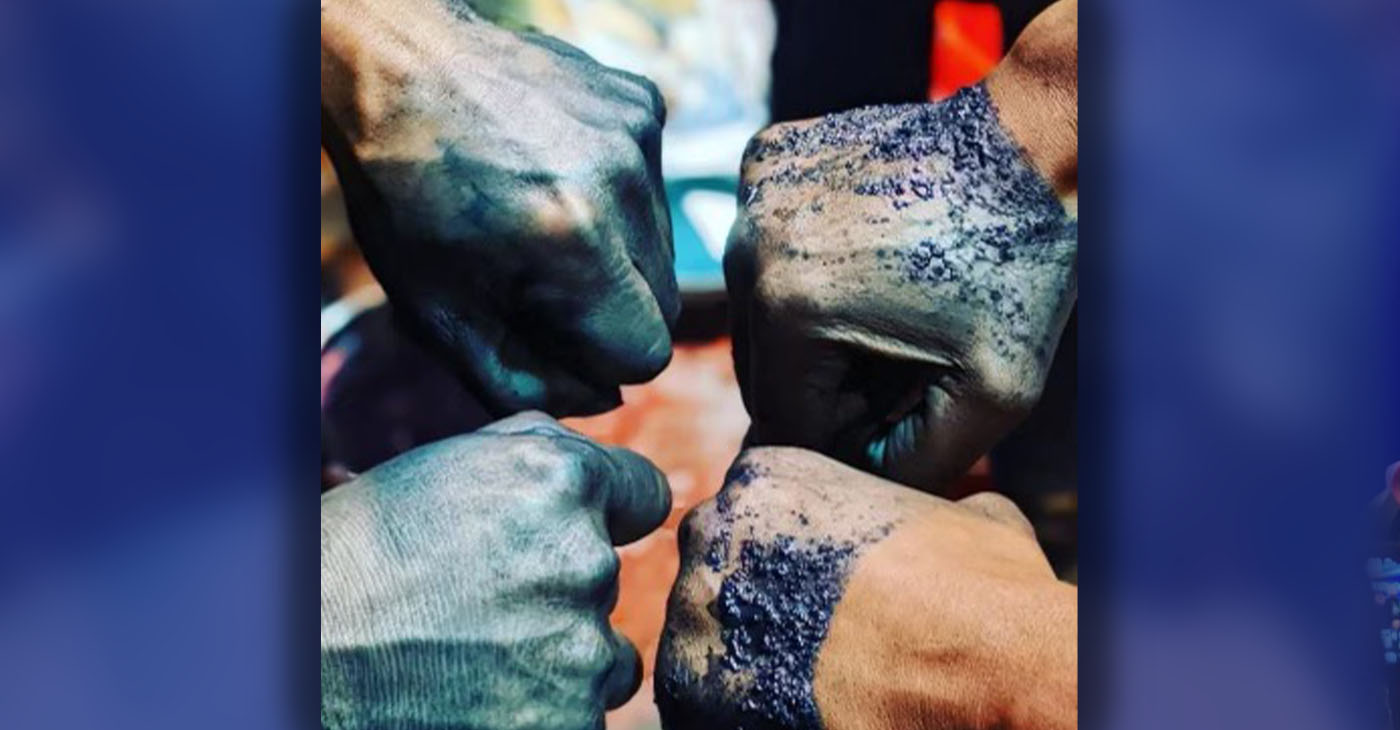 Workshop participants show how the dye looks on their skin. Prolonged exposure over years of dyeing will make the blue skin permanent. Photo courtesy Reshawn Goods