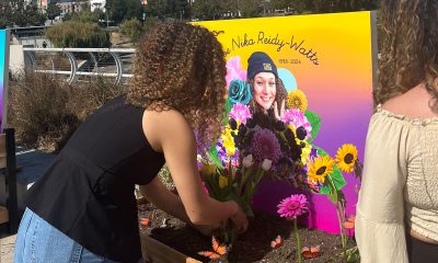 Jada Imani and another Black Tulip attendee building an altar at the Lake Merritt Amphitheater in honor of artist Zoe Reidy Watts, 25, who was killed in Oakland in March. Courtesy photo.