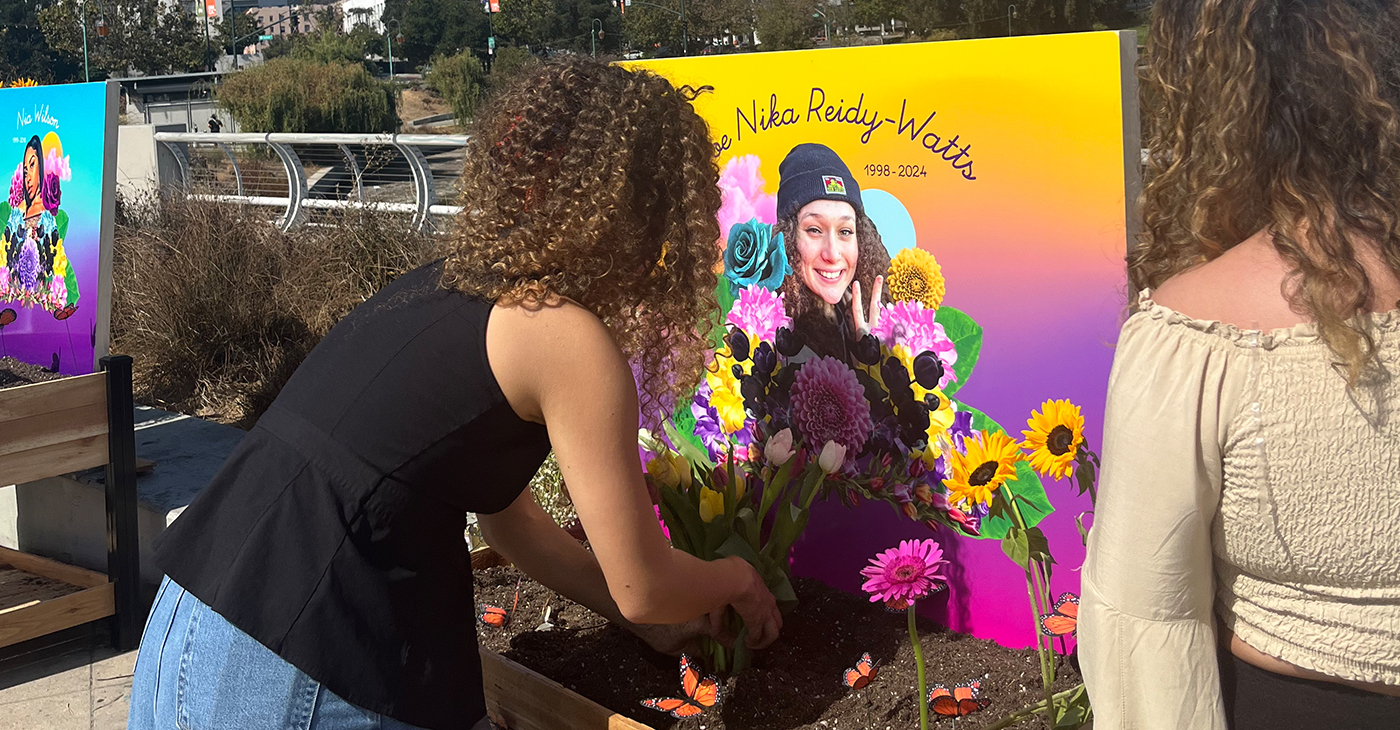 Jada Imani and another Black Tulip attendee building an altar at the Lake Merritt Amphitheater in honor of artist Zoe Reidy Watts, 25, who was killed in Oakland in March. Courtesy photo.