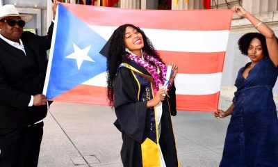 Keyanna Ortiz-Cedeño at her graduation from UC Berkeley after receiving her master’s degree in City Regional Planning. Alongside her, are her parents holding a Puerto Rican flag. Courtesy photo.