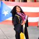 Keyanna Ortiz-Cedeño at her graduation from UC Berkeley after receiving her master’s degree in City Regional Planning. Alongside her, are her parents holding a Puerto Rican flag. Courtesy photo.