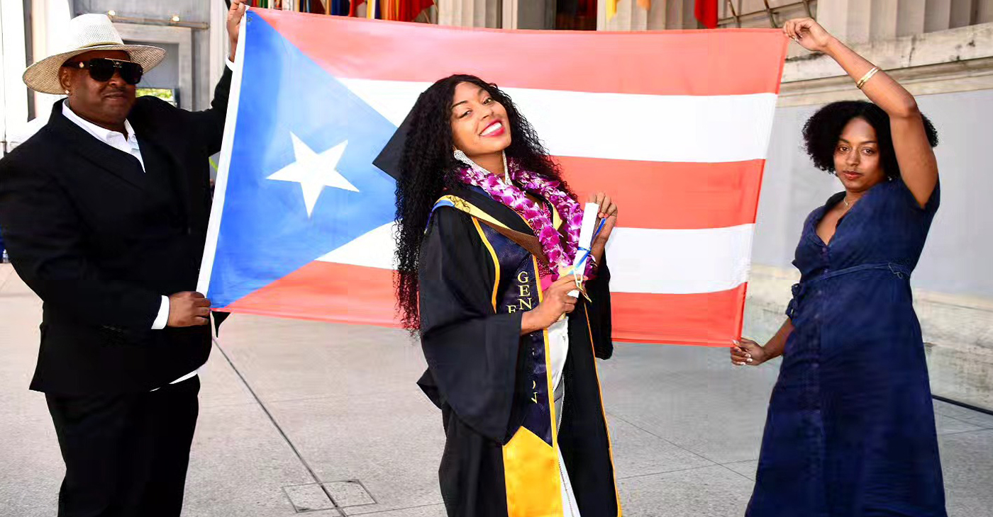 Keyanna Ortiz-Cedeño at her graduation from UC Berkeley after receiving her master’s degree in City Regional Planning. Alongside her, are her parents holding a Puerto Rican flag. Courtesy photo.