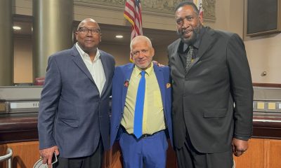 Members of the 1975 NBA championship team, Charles Dudley (left) and Clifford Ray (right) embrace Love Life Foundation leader Donald Lacy for his antiviolence mission. Courtesy photo.