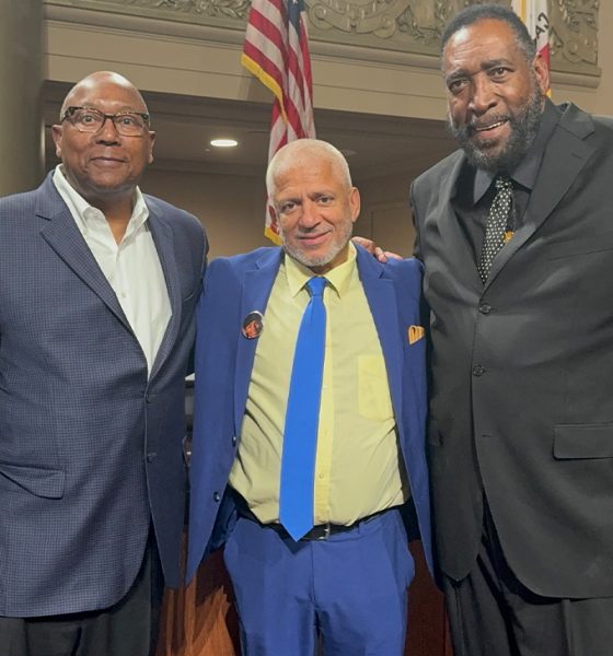 Members of the 1975 NBA championship team, Charles Dudley (left) and Clifford Ray (right) embrace Love Life Foundation leader Donald Lacy for his antiviolence mission. Courtesy photo.