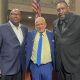 Members of the 1975 NBA championship team, Charles Dudley (left) and Clifford Ray (right) embrace Love Life Foundation leader Donald Lacy for his antiviolence mission. Courtesy photo.