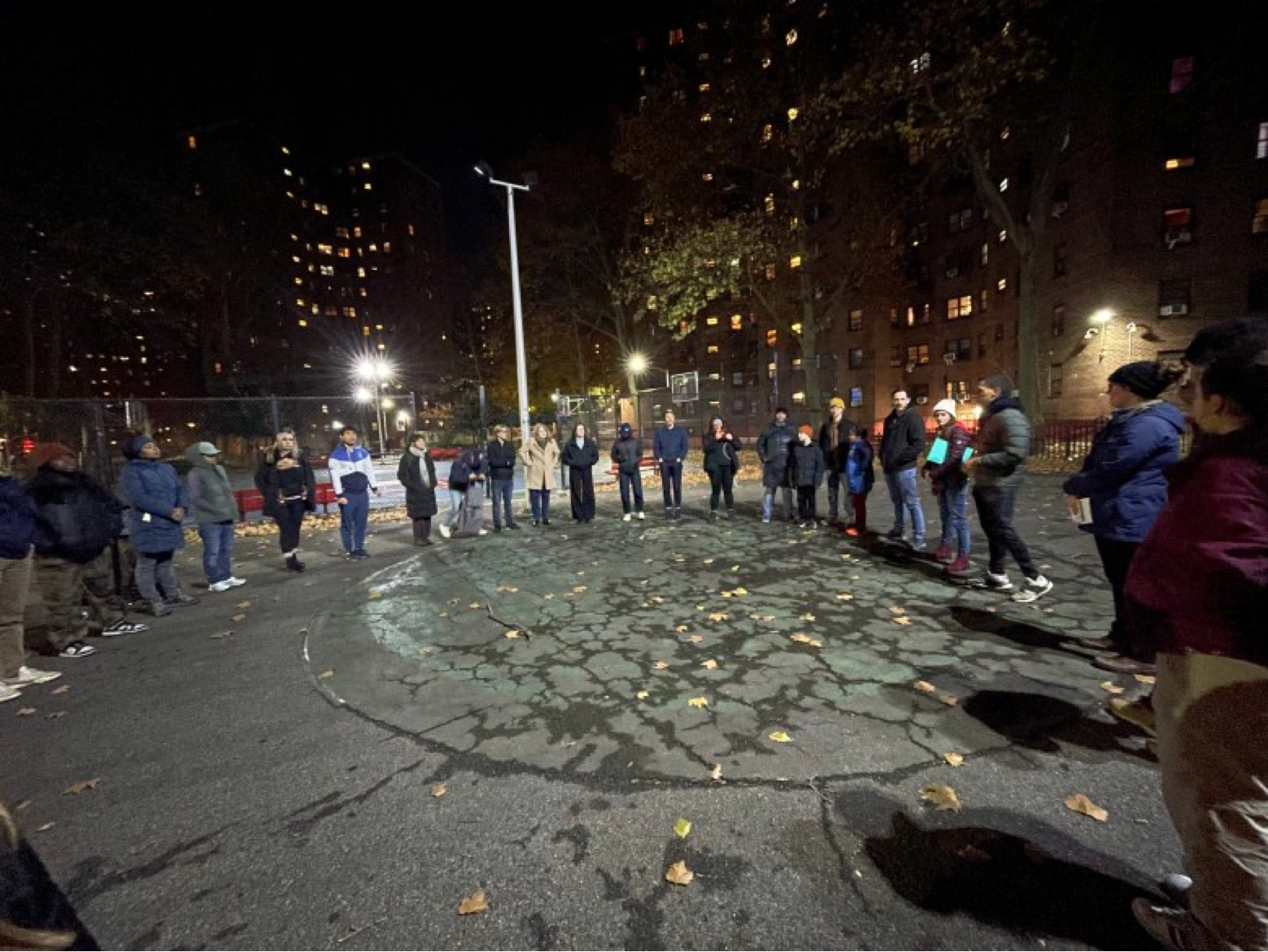 All the volunteers met in the basketball court for their closing group huddle. The group huddle is where the volunteers form a circle and come together to celebrate the wins in this year’s giveaway. Credit: Sherica Daley photo.