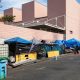 Shutterstock. Los Angeles, CA. USA: 2024 August 01: Homeless, unhoused people living in an encampment, temporary shelters and tents on the sidewalk.