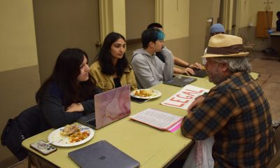 UC Berkeley Law Students help a clinic visitor with legal advice at their Tuesday night services. The Clinic offers a variety of resources, including medical, to those in the community who have little access to these services. Photo by Magaly Muñoz