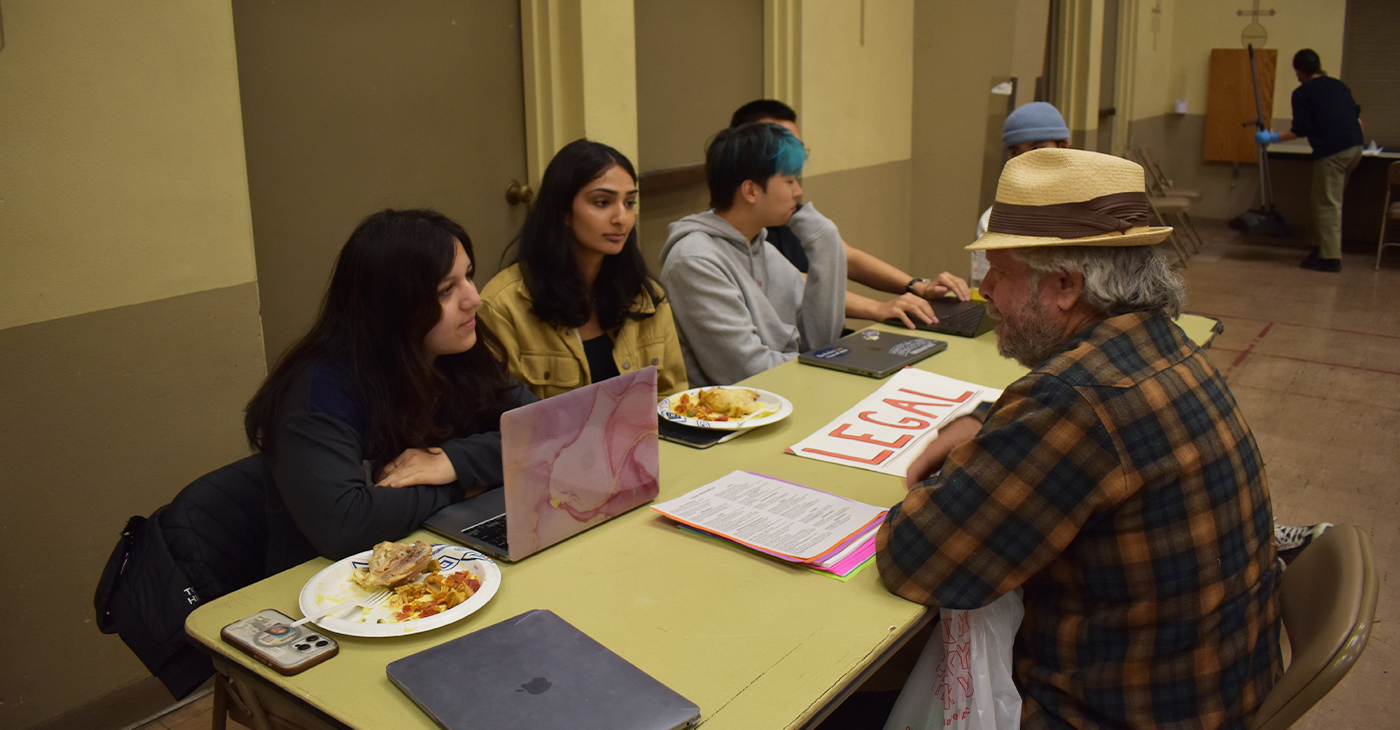 UC Berkeley Law Students help a clinic visitor with legal advice at their Tuesday night services. The Clinic offers a variety of resources, including medical, to those in the community who have little access to these services. Photo by Magaly Muñoz