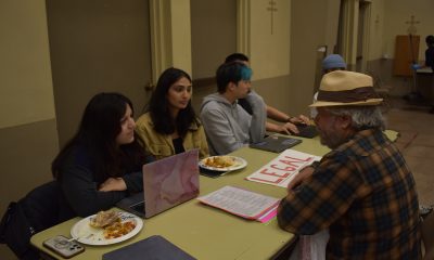 UC Berkeley Law Students help a clinic attendee with legal advice at their Tuesday night services. The Clinic offers a variety of resources, including medical, to those in the community who have little access to these services. Photo by Magaly Muñoz