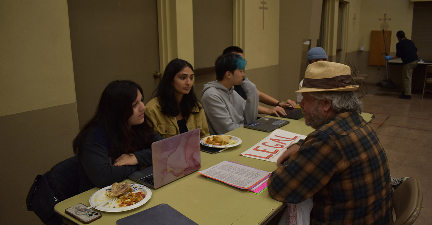 UC Berkeley Law Students help a clinic attendee with legal advice at their Tuesday night services. The Clinic offers a variety of resources, including medical, to those in the community who have little access to these services. Photo by Magaly Muñoz