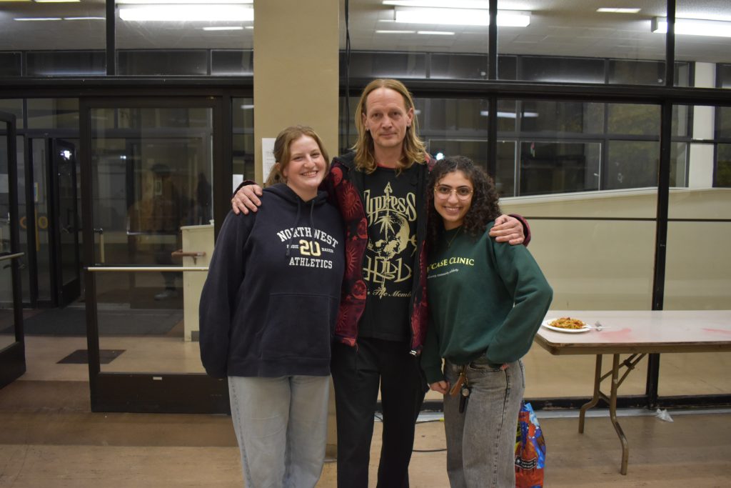 Suitcase Clinic student workers posing for a photo with a frequent clinic attendee. The Clinic is open to Berkeley unhoused and low-income residents who need medical or legal service, or a hot meal. Photo by Magaly Muñoz.