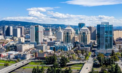 An aerial view of the downtown Oakland skyline on a clear sunny day. The federal building and other iconic buildings fill the skyline. Photo: iStock.