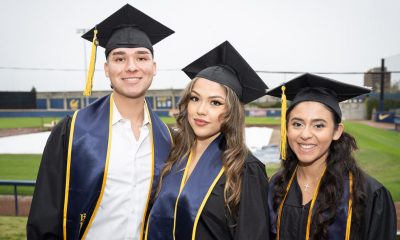 Lester Cedeño, left, and Jamie Hernandez, both of San Bernardino, California, pose with Monica Gomez of Vallejo, right, after the graduation ceremony. Photo by Keegan Houser/UC Berkeley.