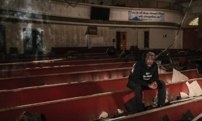 Pastor Rodney sits in the church's sanctuary following the devastating three alarm fire in 2023.