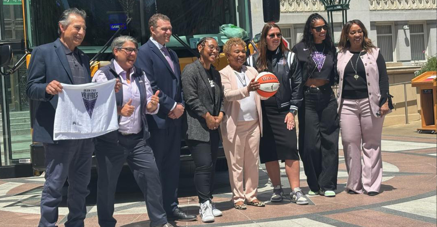 The Valkyries came to Oakland City Hall with a “Hoopbus.” Present were (from left to right): City Councilmembers Noel Gallo, Rebecca Kaplan, Zac Unger and Rowena Brown; Oakland Mayor-elect Barbara Lee, Valkyries President Jess Smith, a Valkyries team representative and Deputy Mayor LaNiece Jones. Photo courtesy Rebecca Kaplan’s office.